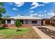 Charming single-story home with a well-manicured lawn, brick accents, and a covered carport at 2122 W Piccadilly Rd, Phoenix, AZ 85015