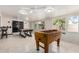 Bright game room with multiple ceiling fans, large windows and a variety of games at 2122 W Piccadilly Rd, Phoenix, AZ 85015