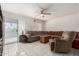 Spacious living room featuring tile floors, a ceiling fan, and a comfortable sectional sofa at 2122 W Piccadilly Rd, Phoenix, AZ 85015