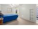 Bright bedroom with plush carpet, ceiling fan, closet and ensuite bathroom at 2122 W Piccadilly Rd, Phoenix, AZ 85015