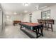 A bright recreation room with a pool table, foosball table, bar, and ample seating at 2122 W Piccadilly Rd, Phoenix, AZ 85015