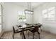 Bright dining room with a modern light fixture and plantation shutters for a clean, fresh aesthetic at 22714 E Parkside Dr, Queen Creek, AZ 85142