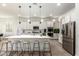 Open kitchen features a large center island with seating, modern appliances, and pendant lighting at 22714 E Parkside Dr, Queen Creek, AZ 85142