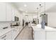 Bright, modern kitchen features sleek white cabinets, stainless steel appliances, and quartz countertops at 22714 E Parkside Dr, Queen Creek, AZ 85142