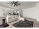 Open-concept living room with plush sectional sofa and adjacent eat-in kitchen for easy entertaining at 22714 E Parkside Dr, Queen Creek, AZ 85142