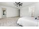 Bright main bedroom boasts carpeted floors, a ceiling fan, and ensuite bathroom access at 22714 E Parkside Dr, Queen Creek, AZ 85142