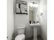 Stylish powder room boasts patterned tile flooring, pedestal sink, and modern light fixtures at 22714 E Parkside Dr, Queen Creek, AZ 85142