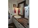 Bathroom features a wooden countertop, framed mirror, and decorative rustic sconces at 2511 N 56Th St, Mesa, AZ 85215