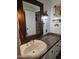 Bathroom featuring a wooden countertop, white cabinetry, rustic mirror, and decorative lighting at 2511 N 56Th St, Mesa, AZ 85215