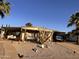 Charming home featuring a covered porch, desert landscaping, and a carport for convenient parking at 2511 N 56Th St, Mesa, AZ 85215
