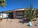 Charming home featuring xeriscape landscaping and a cozy porch swing, perfect for relaxing outdoors at 2511 N 56Th St, Mesa, AZ 85215