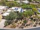 An aerial view of the property showcases the house with solar panels and lush landscaping with desert plants at 28045 N 112Th Pl, Scottsdale, AZ 85262