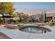 Backyard featuring a spa, a patio area, desert landscaping, and mature trees at sunset at 28045 N 112Th Pl, Scottsdale, AZ 85262