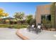 Landscaped backyard featuring lounge chairs, patio, mature trees, and desert landscaping at 28045 N 112Th Pl, Scottsdale, AZ 85262