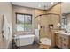 Modern bathroom featuring a standalone tub, large shower, and beautiful vanity with plants at 28045 N 112Th Pl, Scottsdale, AZ 85262