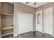 Bedroom featuring tile floors, built-in shelves, and a closet with sliding doors at 28045 N 112Th Pl, Scottsdale, AZ 85262