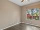 Neutral bedroom featuring tile floors and window with a view of a landscaped yard at 28045 N 112Th Pl, Scottsdale, AZ 85262