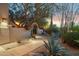 The property entrance features a stone archway and beautiful desert landscaping at dusk at 28045 N 112Th Pl, Scottsdale, AZ 85262