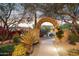 Stone archway entrance with desert landscaping and ambient lighting at 28045 N 112Th Pl, Scottsdale, AZ 85262