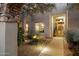 Inviting entrance with a fountain, desert landscaping, and soft lighting for a warm and elegant feel at 28045 N 112Th Pl, Scottsdale, AZ 85262