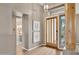 Inviting foyer featuring a modern light fixture, stylish decor, and a view to a nearby bathroom at 28045 N 112Th Pl, Scottsdale, AZ 85262