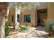 Inviting home exterior with a fountain, desert landscaping, and beautiful natural lighting around the property entrance at 28045 N 112Th Pl, Scottsdale, AZ 85262