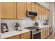 Updated kitchen with stainless steel appliances, quartz countertops, and modern cabinetry at 28045 N 112Th Pl, Scottsdale, AZ 85262