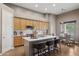 Kitchen island with seating, stainless steel appliances, and adjacent dining area with a glass-top table at 28045 N 112Th Pl, Scottsdale, AZ 85262