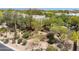 Elevated view of the landscape with desert plants, trees, and partial view of nearby houses at 28045 N 112Th Pl, Scottsdale, AZ 85262