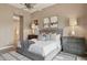 Comfortable main bedroom featuring a ceiling fan, large bed, and art at 28045 N 112Th Pl, Scottsdale, AZ 85262