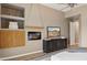 Comfortable main bedroom featuring a ceiling fan, TV, and fireplace at 28045 N 112Th Pl, Scottsdale, AZ 85262
