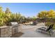 Backyard pool area with built-in grill, lounge chairs, and umbrellas at 28045 N 112Th Pl, Scottsdale, AZ 85262