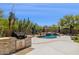 Backyard pool area with an outdoor kitchen and desert landscape, perfect for entertaining at 28045 N 112Th Pl, Scottsdale, AZ 85262