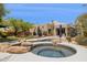 Hot tub in landscaped backyard pool area with desert views and an outdoor kitchen at 28045 N 112Th Pl, Scottsdale, AZ 85262