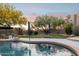Lush backyard pool with mature landscaping and seating for relaxation and recreation at 28045 N 112Th Pl, Scottsdale, AZ 85262