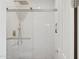 Modern glass shower with subway tile, rainfall shower head, and convenient grab bar at 28045 N 112Th Pl, Scottsdale, AZ 85262