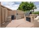 Outdoor kitchen and BBQ area with storage spaces for convenient entertaining at 3022 N 148Th Ave, Goodyear, AZ 85395