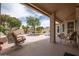 Outdoor patio with comfortable seating overlooking a refreshing pool and lush landscaping at 3022 N 148Th Ave, Goodyear, AZ 85395