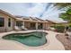 Backyard featuring a pool, solar panels, and an outdoor seating area for relaxation at 3022 N 148Th Ave, Goodyear, AZ 85395