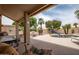 Backyard oasis with a shaded patio, a sparkling pool, and vibrant landscaping at 3022 N 148Th Ave, Goodyear, AZ 85395