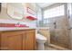 Bright bathroom featuring a tiled shower and red accents at 3022 N 148Th Ave, Goodyear, AZ 85395