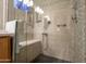 Luxurious walk-in shower featuring decorative tile, a built-in bench, and modern fixtures for a spa-like experience at 3022 N 148Th Ave, Goodyear, AZ 85395