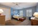 Comfortable bedroom with carpet, cool color palette, ceiling fan and window shutters at 3022 N 148Th Ave, Goodyear, AZ 85395