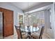 This breakfast nook features a glass table, four chairs, and an outdoor view at 3022 N 148Th Ave, Goodyear, AZ 85395