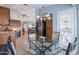This breakfast nook features a glass table, four chairs, and access to the kitchen at 3022 N 148Th Ave, Goodyear, AZ 85395