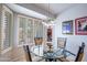 This breakfast nook features a glass table, four chairs, and shutters for privacy at 3022 N 148Th Ave, Goodyear, AZ 85395
