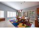 Bright dining room with shuttered windows, comfortable seating, and modern chandelier at 3022 N 148Th Ave, Goodyear, AZ 85395