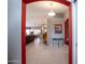 Open foyer leading to a spacious living area with tile flooring, decorative lighting, and neutral wall colors at 3022 N 148Th Ave, Goodyear, AZ 85395