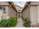 Inviting front entrance featuring a decorative security door, desert landscaping, and a well-lit porch at 3022 N 148Th Ave, Goodyear, AZ 85395