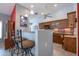 Kitchen bar with seating, decorative tile backsplash, and ample cabinet space at 3022 N 148Th Ave, Goodyear, AZ 85395